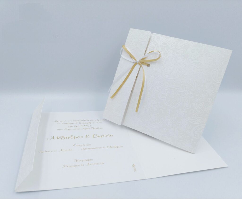 Προσκλητήρια γάμου πολυτελείας U014 λευκό με ανάγλυφες λεπτομέρειες και κορδέλα σε ειδικό ανάγλυφο χαρτί, της εταιρίας  NewAge invitations