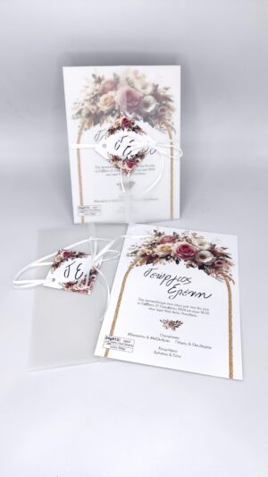 Προσκλητήριο γάμου με τριαντάφυλλα, ριζόχαρτο, λευκή κορδέλα και καρτάκι με μονογράμματα. Η εσωτερική κάρτα έχει χρυσές γραμμές και στεφάνι από ρομαντικά τριαντάφυλλα.
